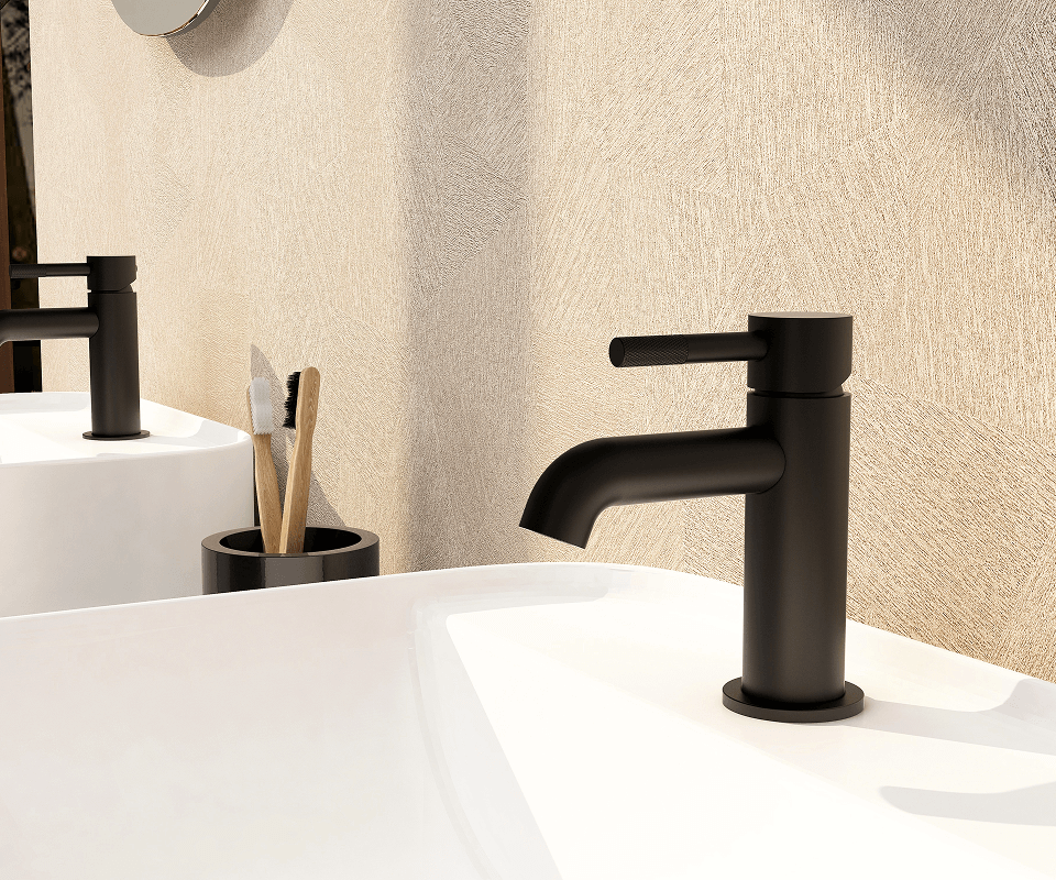 a white sink and a matte black faucet