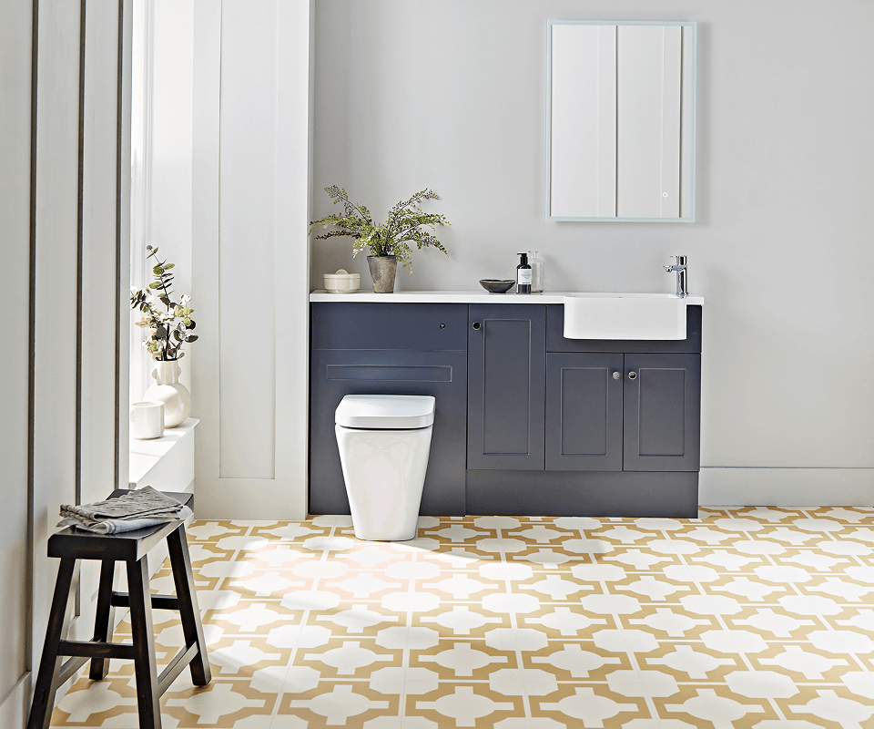 a modern bathroom showcasing a white toilet and a stylish blue cabinet for storage
