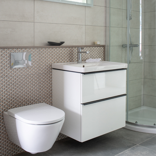 toilet and sink attached to walk with walk in shower in corner of the room