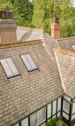 rooftop view of tiled roof with two windows on the roof