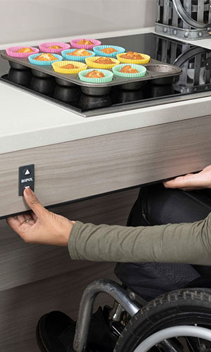 lady pressing button to adjust worktop