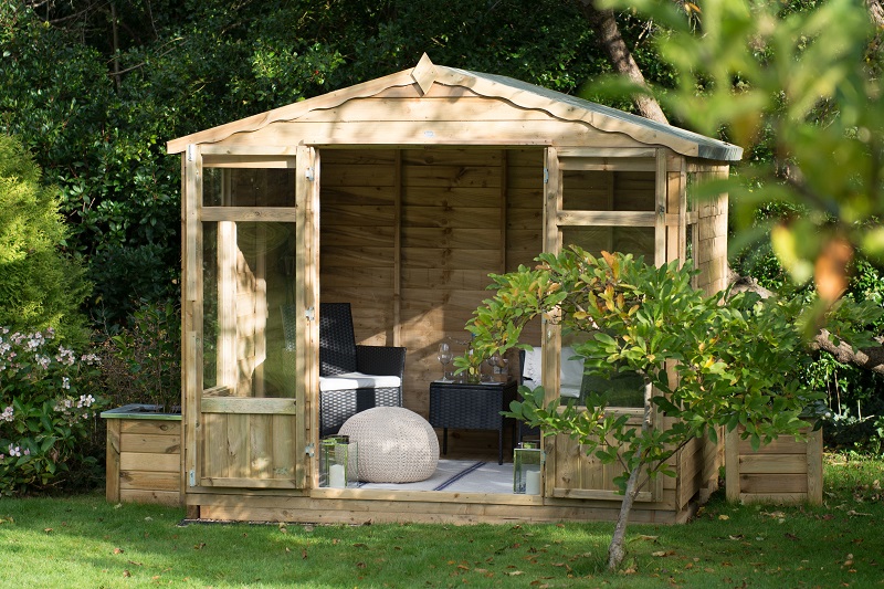 summerhouse with open doors containing seating area with chairs and tables
