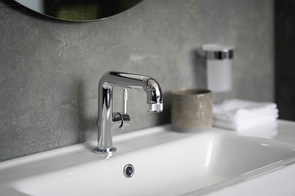 silver tap attached to sink