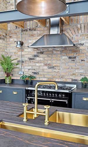 black counter to with warm brass, bronze or copper sink and taps