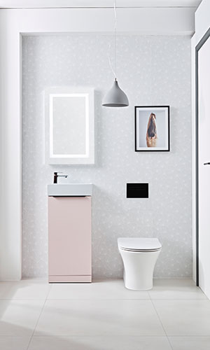 front view of lavatory with white sink, black tab and pink base with rectangle mirror with built in light