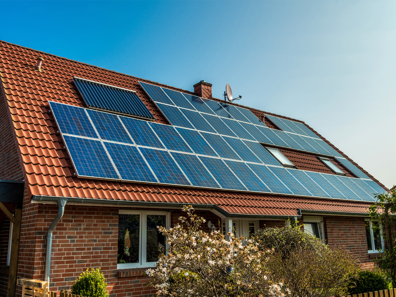 front view of house with many solar panels on the roof