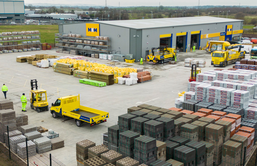 drone view of MKM warehouse with many vehicles, workers and products