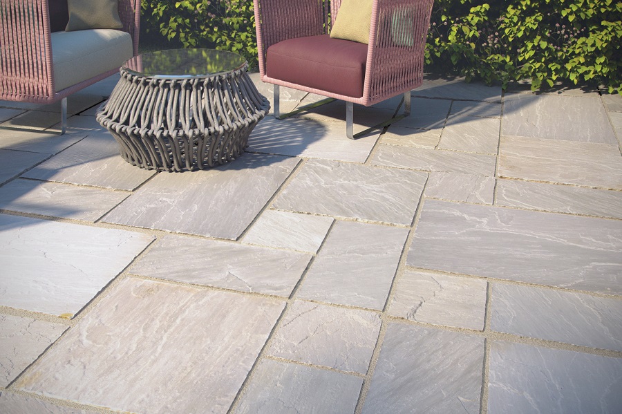 Stone paving with small circle table and red netted chairs with metal legs